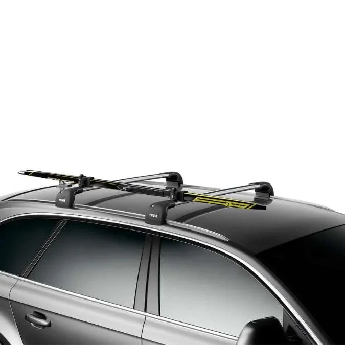 Thule SkiClick mounted on roof rack of a silver car with cross-country skis secured
