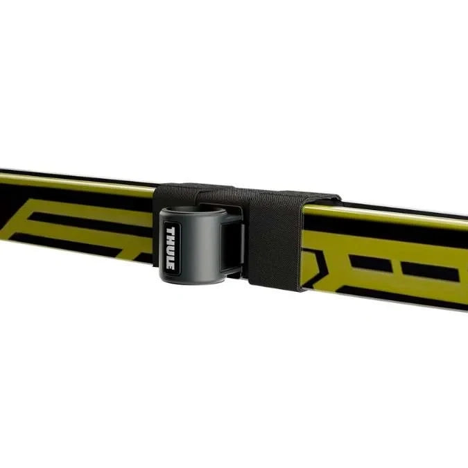 Thule SkiClick strap securing yellow cross-country skis