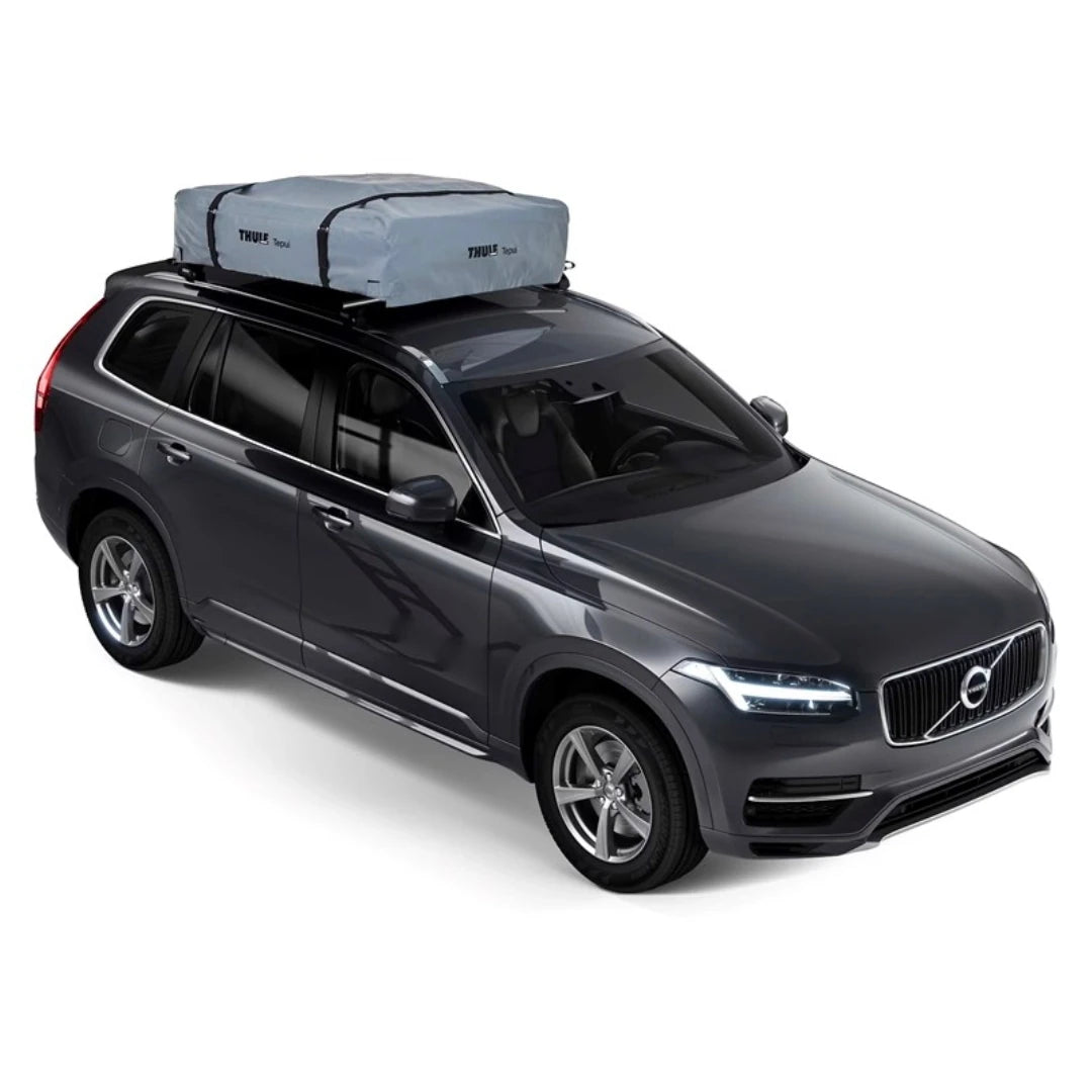 Side view of tan rooftop tent deployed on vehicle