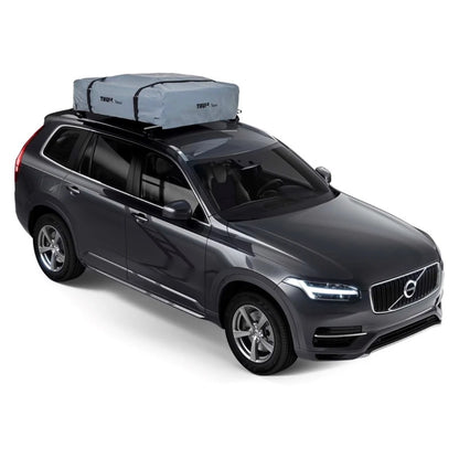 Side view of tan rooftop tent deployed on vehicle