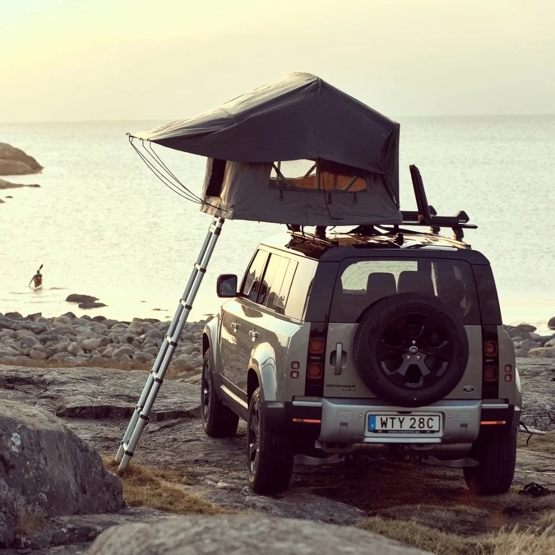 Thule Tepui Foothill Rooftop Tent set up on car parked at the ocean
