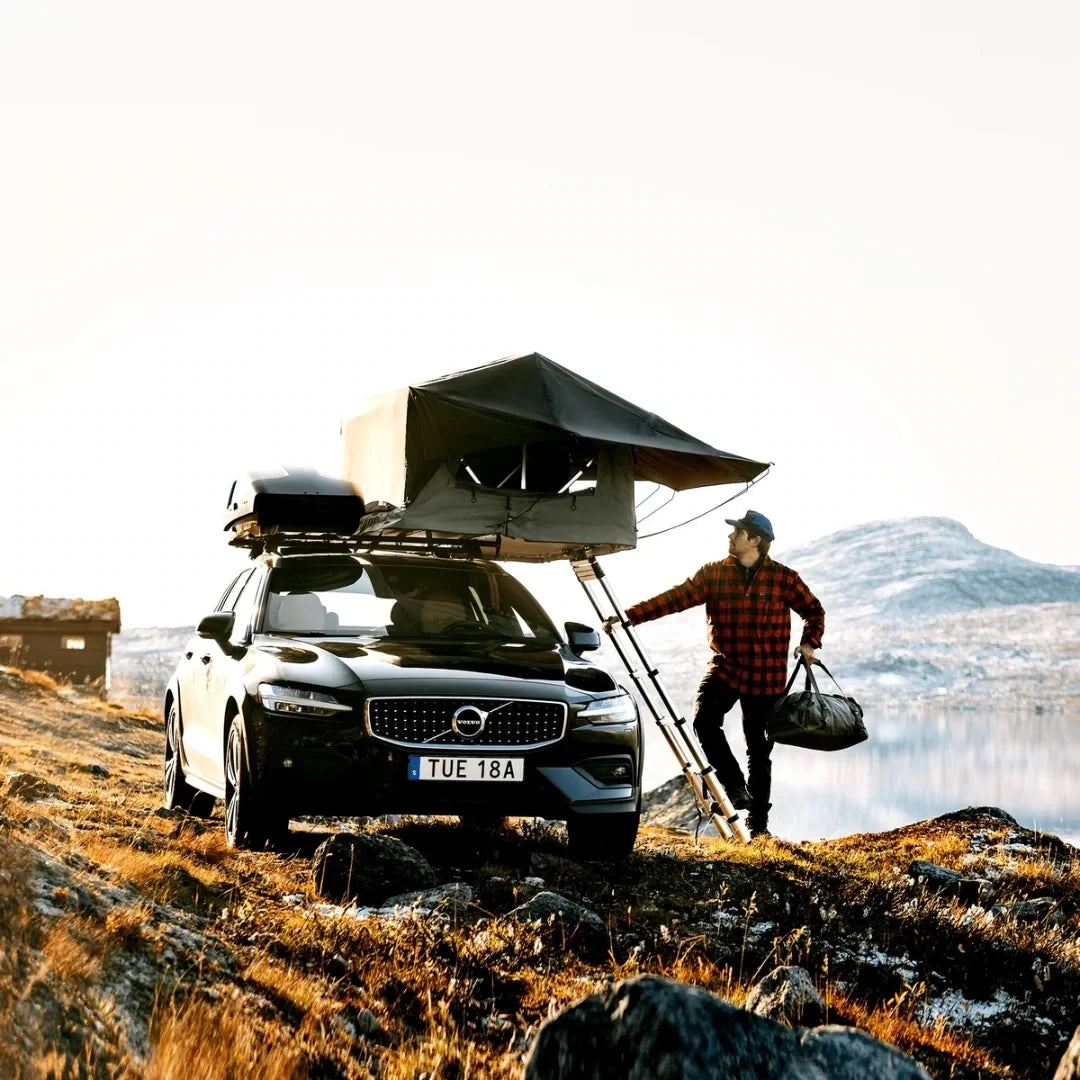 Thule Tepui Foothill Rooftop Tent set up on car parked in the mountains on uneven terrain