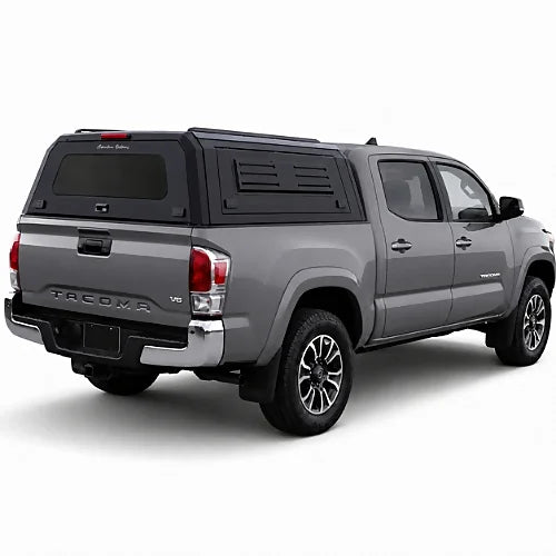 GullWing aluminum truck cap with tinted rear glass and lockable side doors on an overland pickup truck