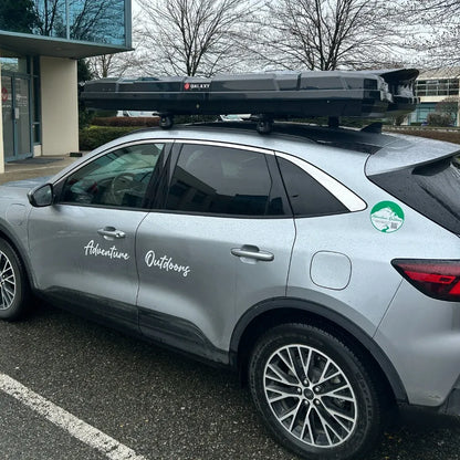 AO slim alpine cargo box mounted on silver SUV with Adventure Outdoors branding
