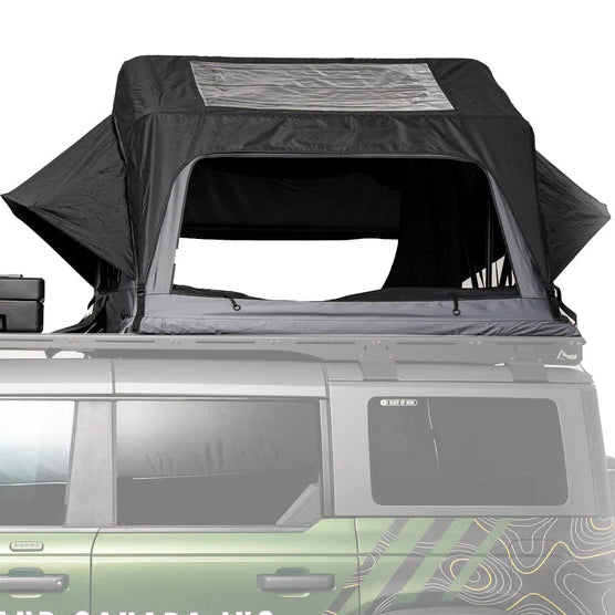 Roof top tent on a vehicle with Overland Canada Inc. branding.