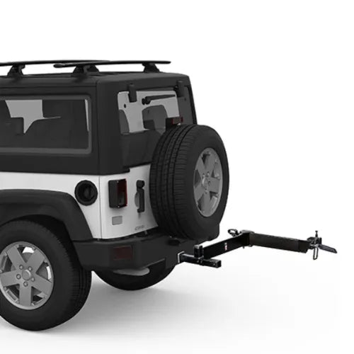 Black and white SUV with a spare tire on the back and a hitch attached, on a white background