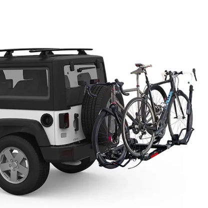 Bicycle rack attached to a vehicle with two bicycles on a white background