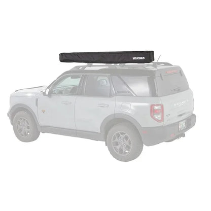 Yakima OverNOut 270 LG and XL rooftop awning in closed position mounted on SUV roof rack, showcasing compact overlanding shade system from Adventure Outdoors Canada.