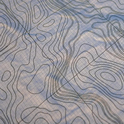 Close-up of Yakima OverNOut 270 rooftop awning fabric featuring durable ripstop material and topographic contour pattern, designed for weather resistance, strength, and premium overlanding camping performance.