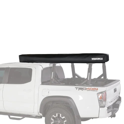 Yakima OverNOut 270 rooftop awning in closed travel position mounted on pickup truck bed rack, showcasing compact storage design, secure transport, and ready-to-deploy overlanding shelter for outdoor adventures.