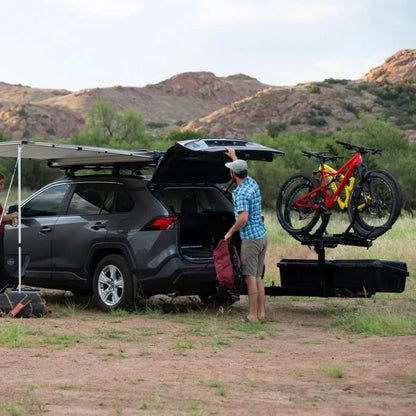 attached to car parked under a tarp in mountain environment