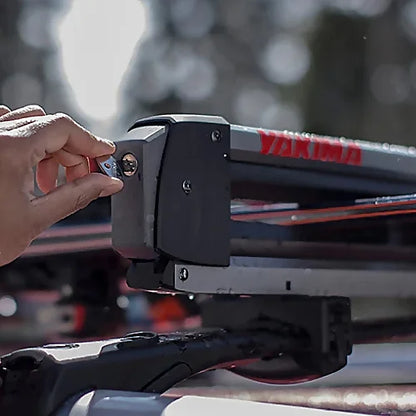 Person locking Yakima FreshTrack ski rack with included SKS key system.