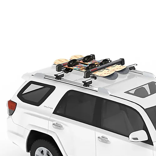 SUV with Yakima FreshTrack ski rack carrying multiple snowboards on the roof.