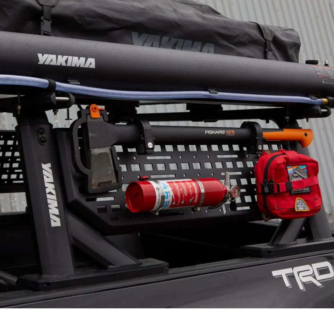 Yakima roof rack system on a vehicle with fire extinguisher and first aid kit.