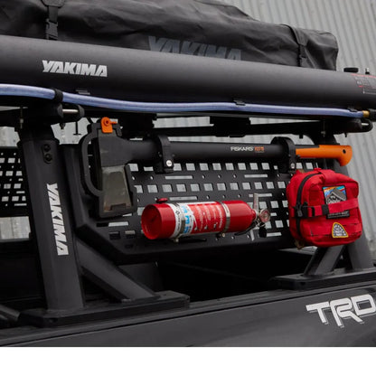 Yakima roof rack system on a vehicle with fire extinguisher and first aid kit.