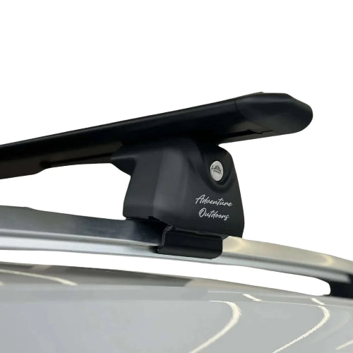 AetherBars raised rail roof rack crossbars installed with aerodynamic low-profile bar and anti-theft lock