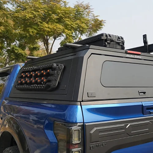 Aluminum truck canopy with roof rack mounts, storage box, tinted side panel, and MOLLE accessory panel