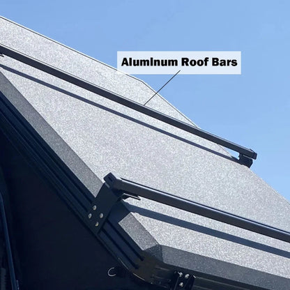 Close-up angled view of aluminum roof bars mounted on a rooftop tent