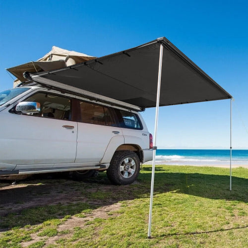 AO roof rack awning with integrated LED lights mounted on SUV, providing shade and shelter for beach camping setup