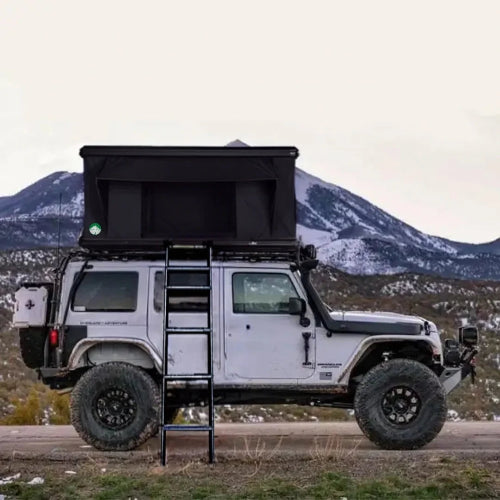 Adventure Outdoors Camp-In AO Rooftop Tent setup on Jeep with mountain background