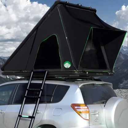 Cocoon AO 2025 Clamshell Rooftop Tent mounted on SUV with open windows and ladder in scenic mountain area
