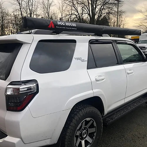 Dog House vehicle awning closed in black PVC cover on SUV roof rack