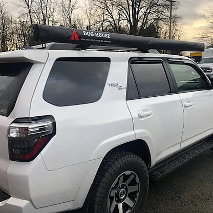 Dog House vehicle awning closed in black PVC cover on SUV roof rack