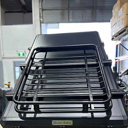 Foldable cargo basket mounted on rooftop tent with aluminum bars from Adventure Outdoors