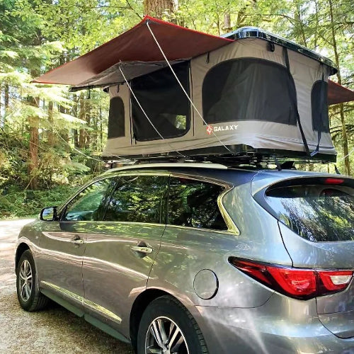 Galaxy Pop-Up Rooftop Tent fully set up on SUV in a forest campsite