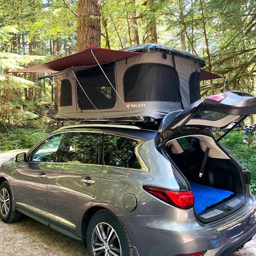 SUV with Galaxy Pop-Up Tent deployed and trunk open showing storage