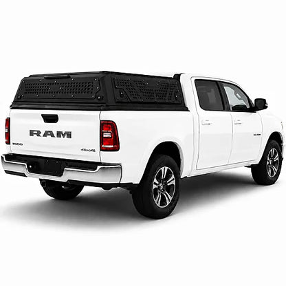 White Ram truck with a black low profile truck topper on a white background