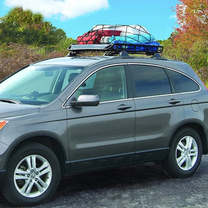 SUV with Highland U-Venture cargo basket loaded with colorful gear bags on the roof, parked in a scenic outdoor setting