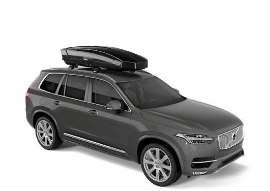Gray SUV with a roof rack on a white background