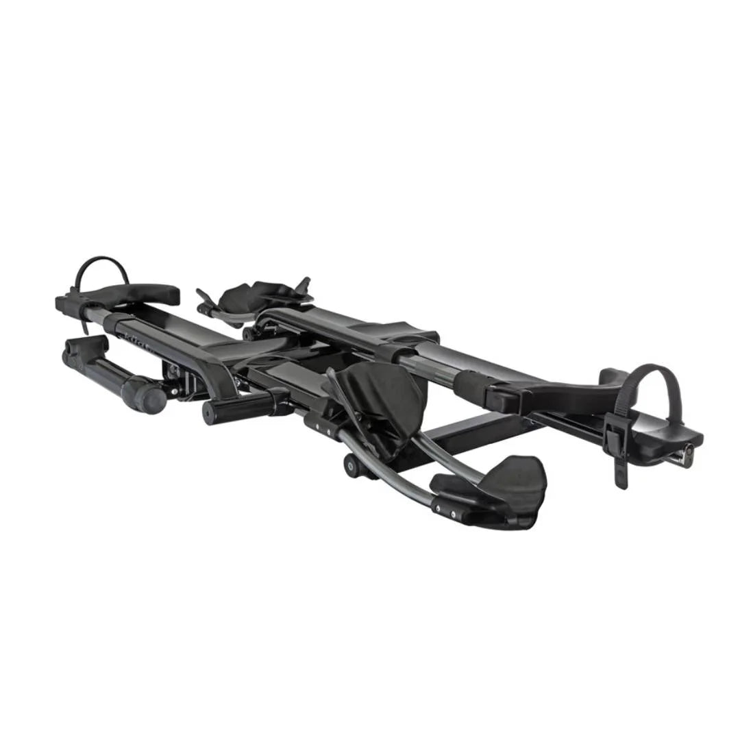 Angled front view of the Kuat NV 2.0 hitch bike rack showing trays and arm supports.

