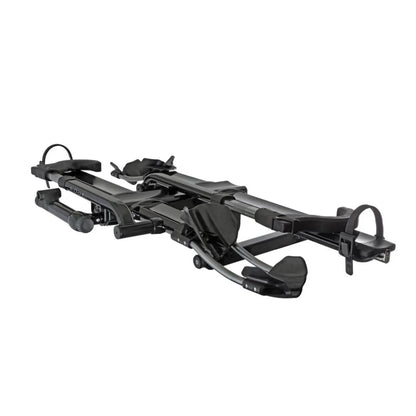 Angled front view of the Kuat NV 2.0 hitch bike rack showing trays and arm supports.

