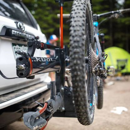 Zoomed-in view of front tire mounted securely in the rack arm hook.