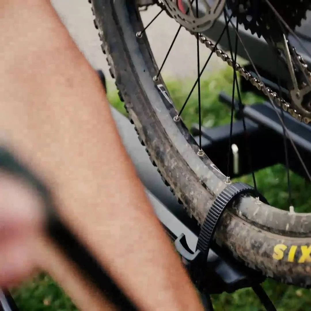 Detail of rear bike wheel secured in the Kuat NV 2.0 wheel tray.