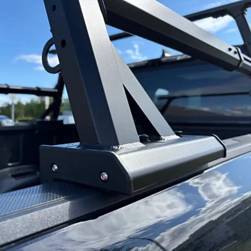 Matte black mounting foot of truck bed rack on vehicle bed rail