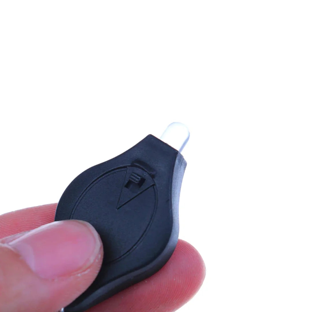Hand holding AO mini flashlight keychain close-up view
