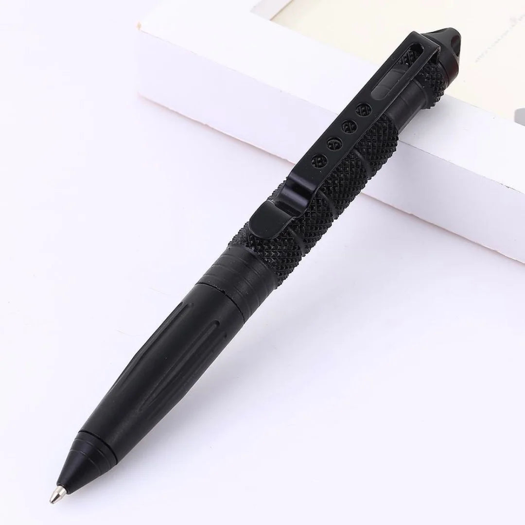 Tactical pen placed on a white surface, showcasing its sleek black finish