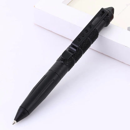 Tactical pen placed on a white surface, showcasing its sleek black finish