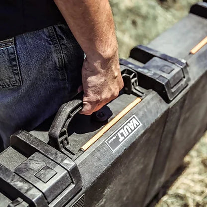 Man carrying Pelican V700 Vault Case in outdoor setting