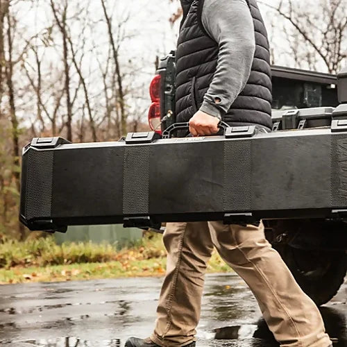 Pelican V770 Vault Single Rifle Case beside hunting gear in outdoor field