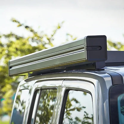 Closed ReTract AO Auto Retractable Awning mounted on roof rack, streamlined aluminum cassette for SUV or off-road vehicles
