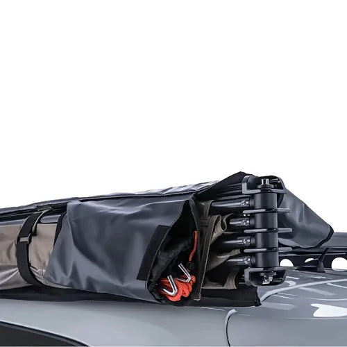 Awning frame and accessories folded into storage position on roof