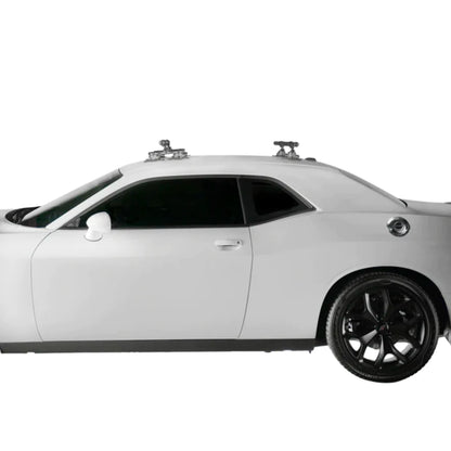 SeaSucker Monkey Bars installed on the roof of a sleek black coupe.