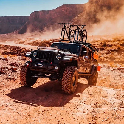 Jeep equipped with SeaSucker Ridge Ready Monkey Bars carrying bikes on off-road desert adventure