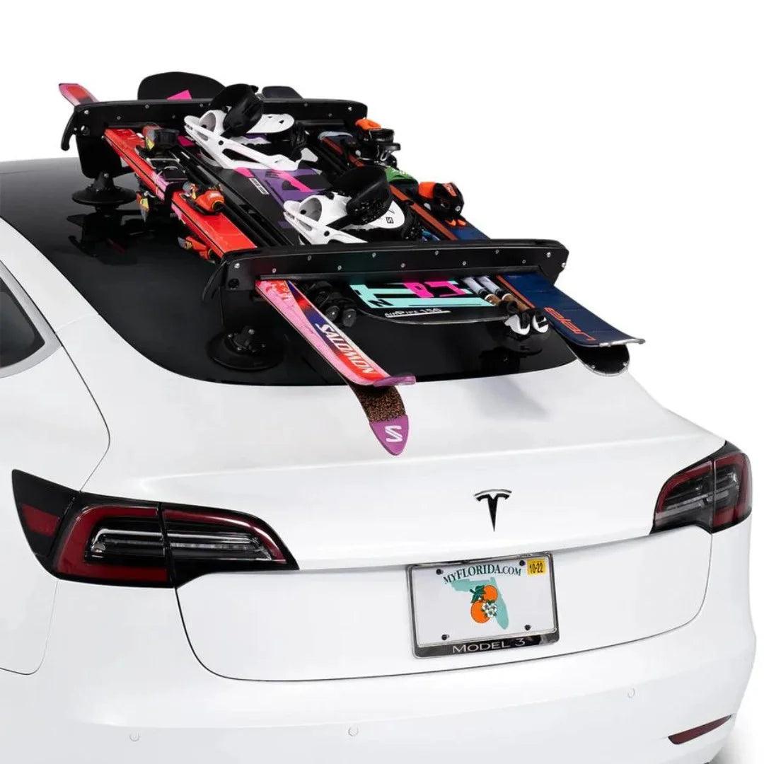 Rear view of rack with skis and snowboards loaded on car.