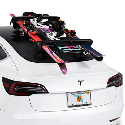 Rear view of rack with skis and snowboards loaded on car.