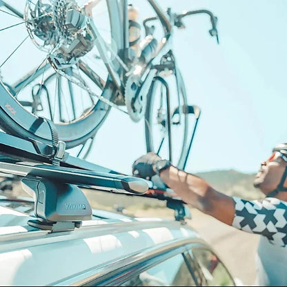 Low-profile SightLine roof rack tower attached to flush-mounted side rails on vehicle with mounted bike